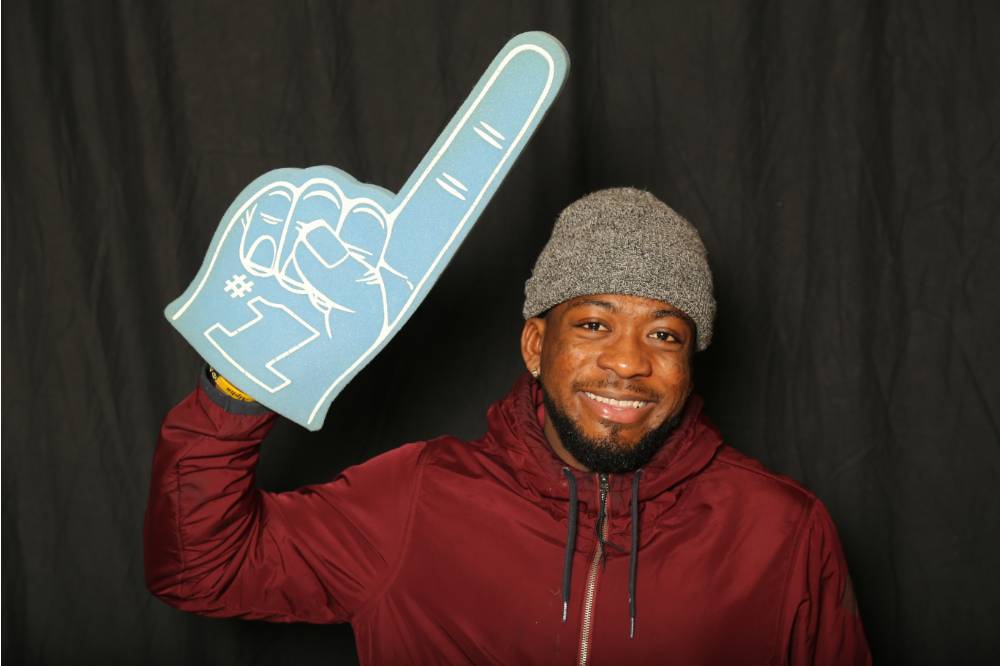 student uses foam finger for a picture